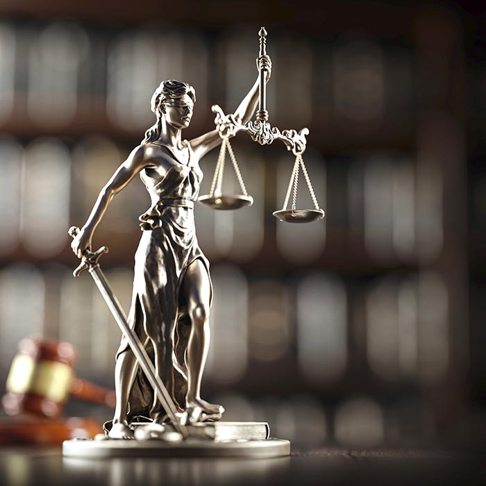 Legal Concept: Themis is the goddess of justice and the judge's gavel hammer as a symbol of law and order on the background of books